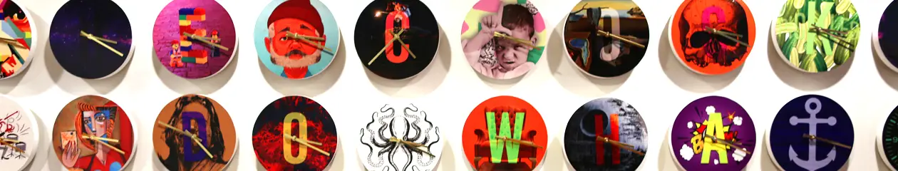 a wall of clocks with different art