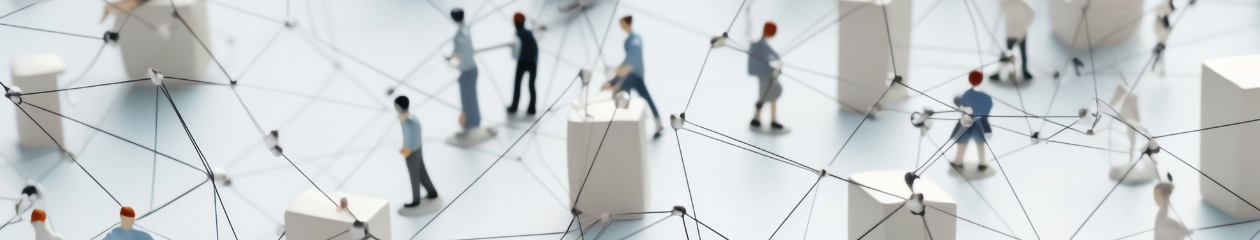 Micro toy people dispersed between boxes and strings to represent a network of people