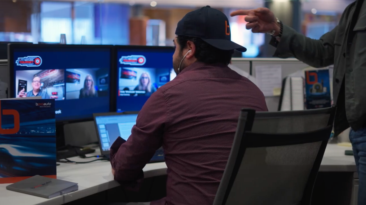 Man sitting in front of computer watching casting