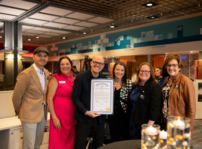 Mark Bellissimo holds a certificate with the Mayor of Farmington Hills, Therese Rich, and others at the JRT agency's 50 Forward event