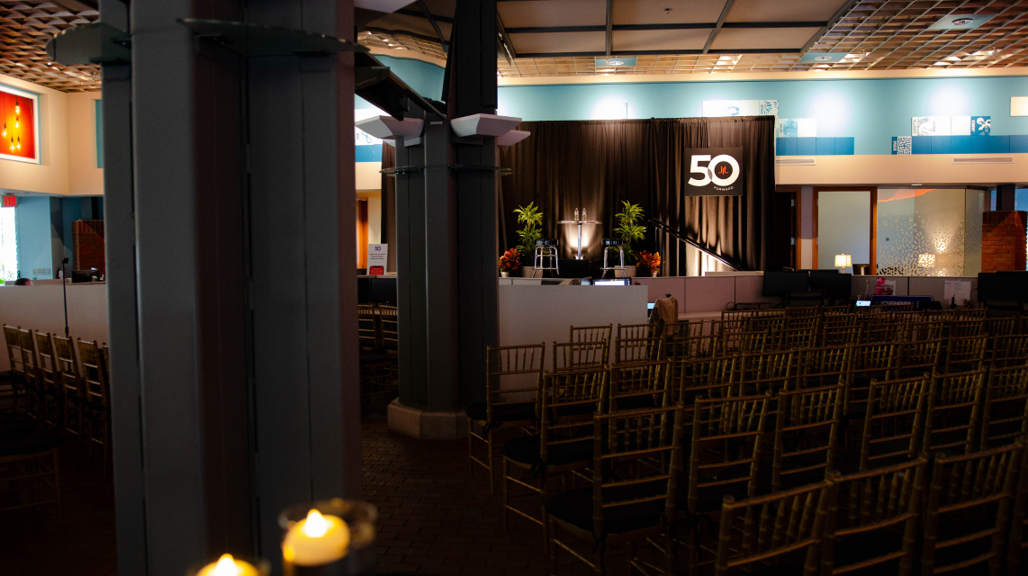 The JRT agency event photo of lighted stage and 50th logo