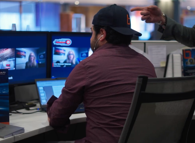 Man sitting in front of computer watching casting