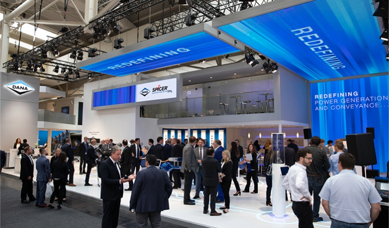 Attendees mingle in front of the Dana tradeshow booth