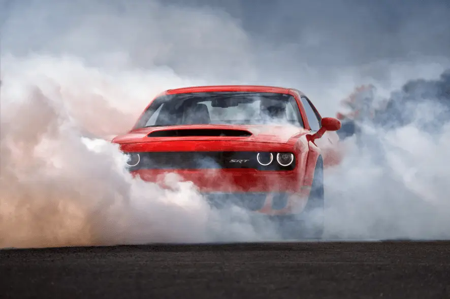 Dodge charger car in a cloud of smoke